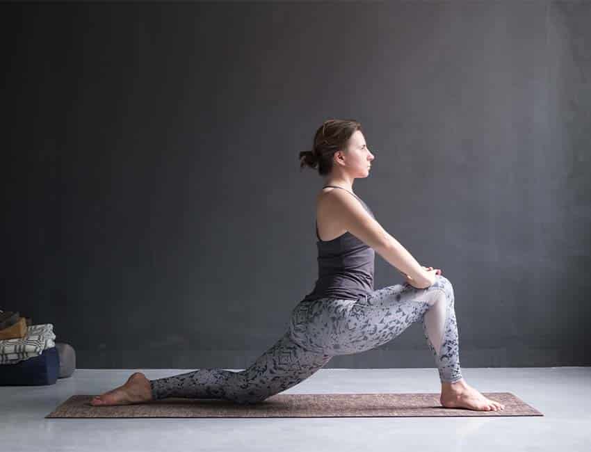 Woman stretching in a kneeling lunge