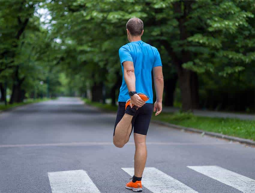 Man warming up with a thigh stretch