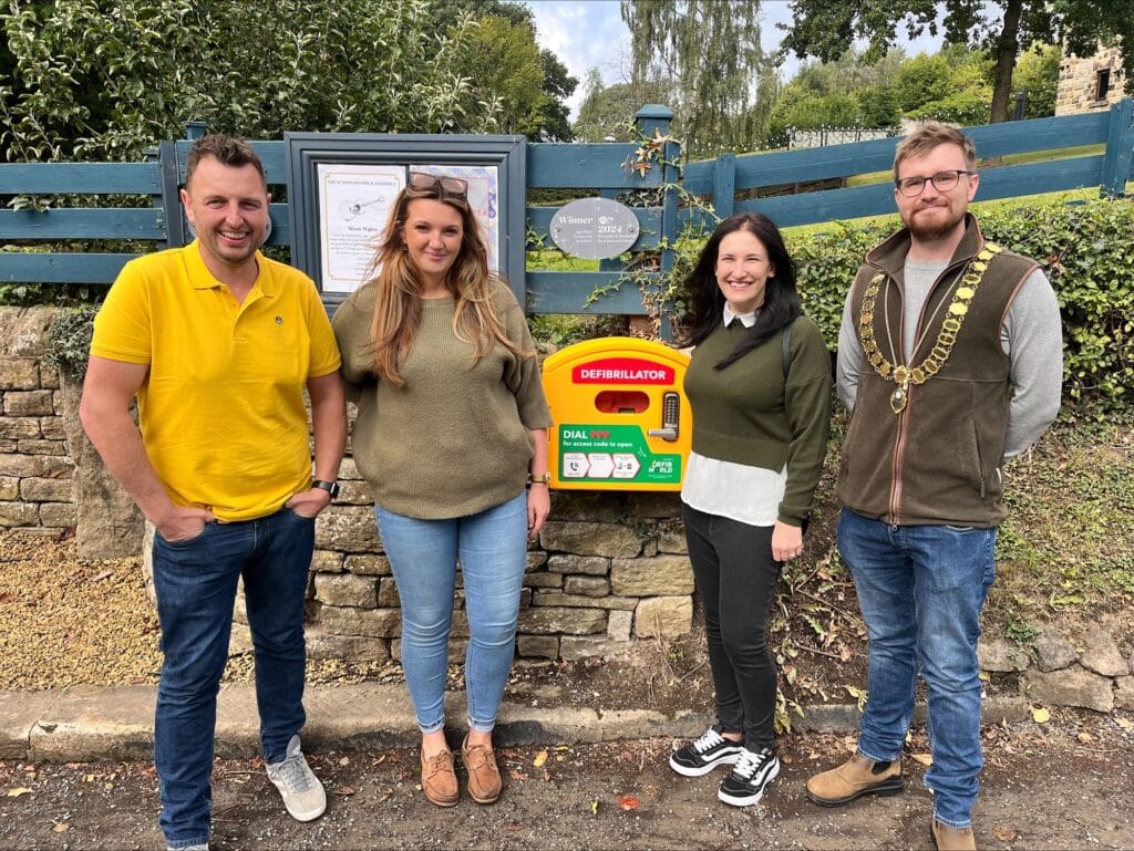 The Schoolrooms Bradfield Ltd with a defibrillator donated by Westfield Health