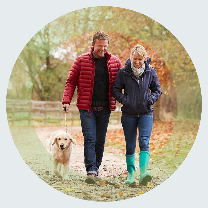Couple walking their dog